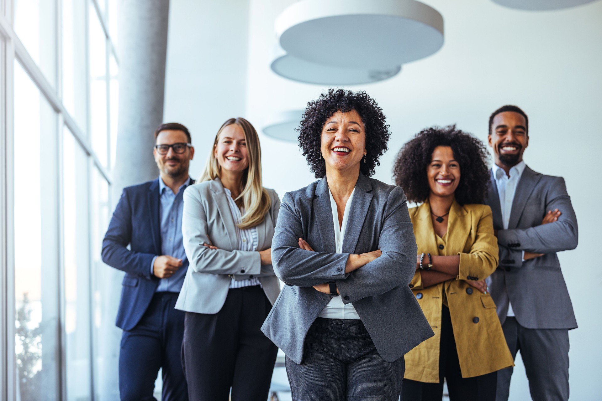 Confident Team of Professionals Standing Together in Corporate Setting Confident Team of Professionals Standing Together in Corporate Setting